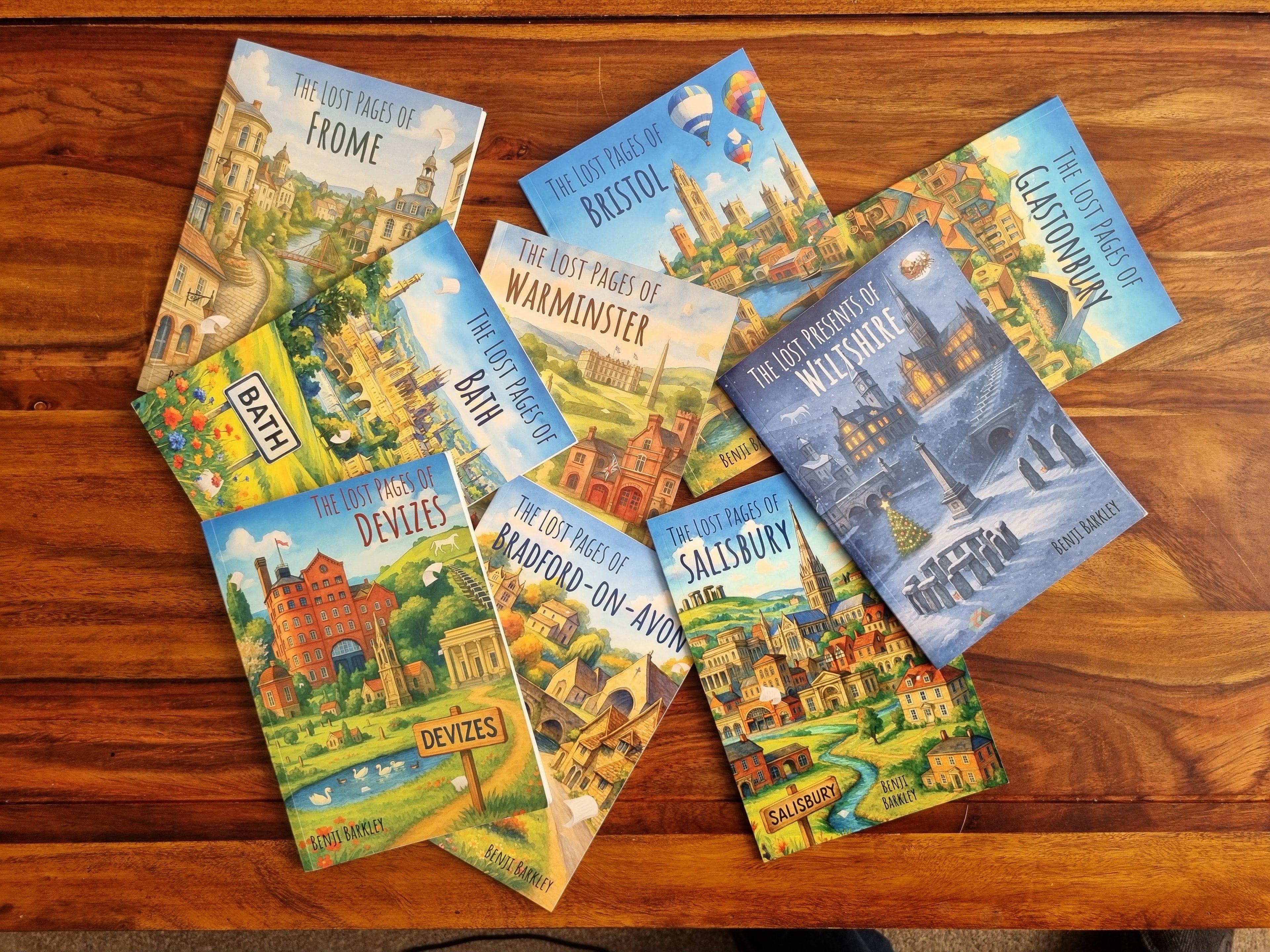 Collection of Benji's books on a wooden surface